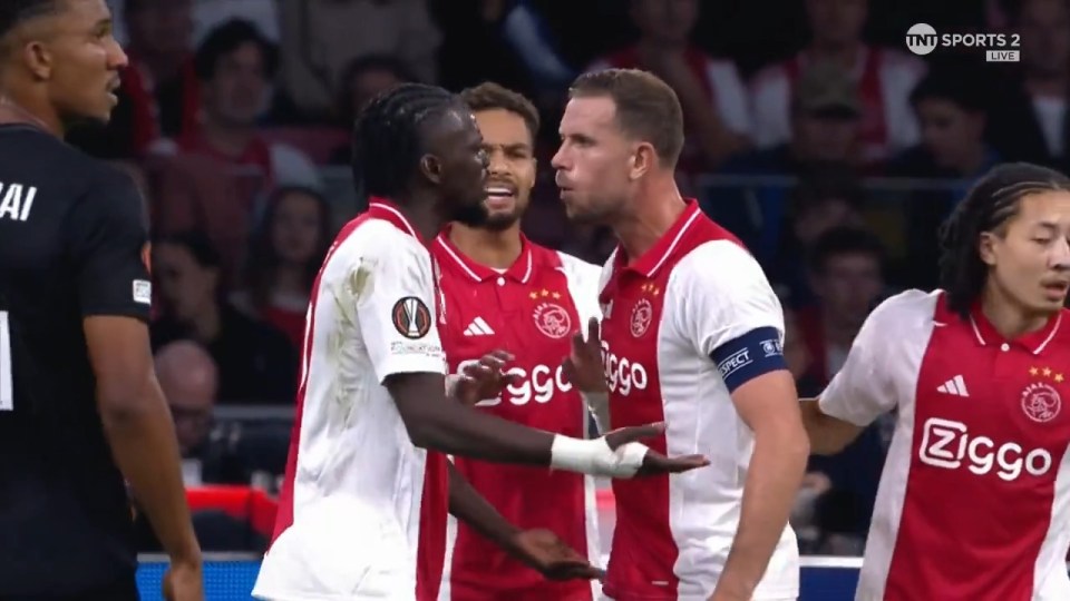 You are currently viewing Jordan Henderson squares up to Ajax teammate Bertrand Traore before giving X-rated view of ex-Chelsea star during Europa League clash