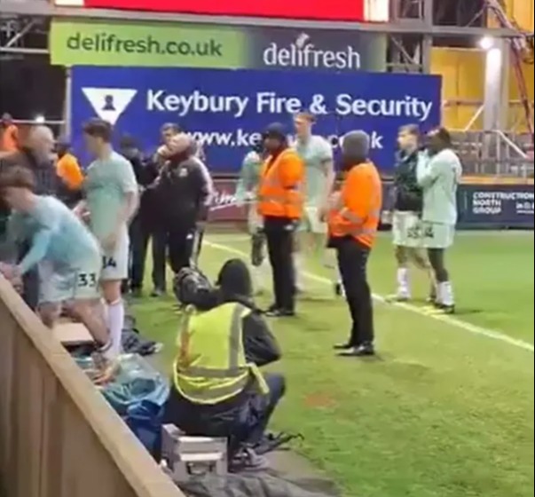 You are currently viewing Ian Holloway restrained by his own players after heated argument with Swindon fan